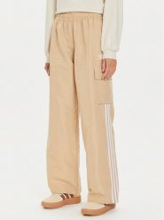 Adidas Spodnie dresowe adicolor 3-Stripes IZ0717 Beżowy Loose Fit. Brązowe spodnie dresowe damskie Adidas, bez wzorów, z dresówki. Za 209.99 zł.