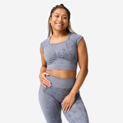 Koszulka fitness damska Domyos crop top seamless. Szare bluzki damskie DOMYOS, s, bez wzorów, z materiału, sportowe, bez kołnierzyka, bez ramiączek. Za 89.99 zł.