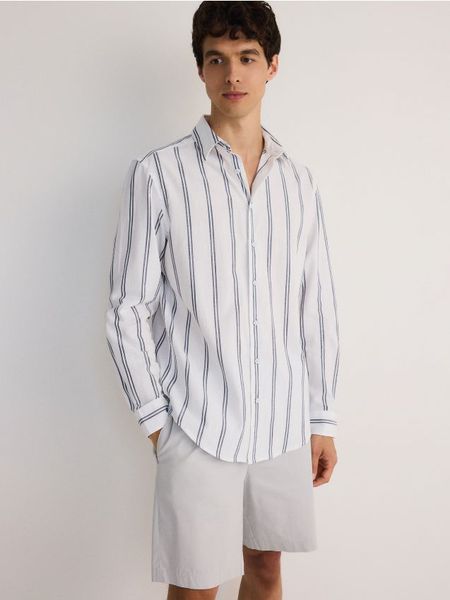 Koszula regular fit w paski - jasnoniebieski. Niebieskie koszule męskie Reserved, l, bez wzorów, z bawełny, bez kołnierzyka, bez ramiączek. Za 139.99 zł.