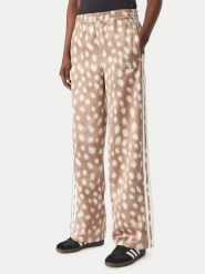 Adidas Spodnie dresowe Firebird KT2144 Brązowy jasny Wide Leg. Brązowe spodnie dresowe damskie Adidas, bez wzorów, z dresówki. Za 349.99 zł.