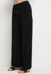 Czarne Spodnie Bawełniane Szerokie z Gumką w Pasie Efranica. Czarne spodnie materiałowe damskie Born2be, bez wzorów, z bawełny, eleganckie. Za 39.99 zł.