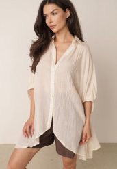 Beżowa Zwiewna Koszula Letnia Oversize z Bawełny o Nietoperzowym Kroju Canomela. Brązowe koszule damskie Born2be, l, bez wzorów, z bawełny, eleganckie, bez kołnierzyka, bez ramiączek. Za 139.99 zł.
