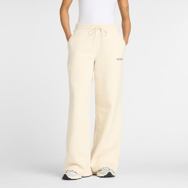 Spodnie damskie New Balance WP53903LIN – beżowe. Brązowe spodnie materiałowe damskie New Balance, z aplikacjami, z bawełny, klasyczne, z podwyższonym stanem. Za 279.99 zł.