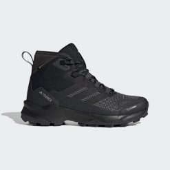 Buty trekkingowe Terrex Skychaser AX5 Mid GORE-TEX CLIMAWARM+. Czarne trekkingi męskie Adidas, z gore-texu, bez zapięcia. W wyprzedaży za 594.15 zł.