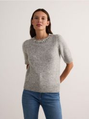 Sweter z biżuteryjną aplikacją - szary. Szare swetry nierozpinane damskie Reserved, l, z aplikacjami, z dzianiny, bez kołnierzyka, bez ramiączek. W wyprzedaży za 99.99 zł.