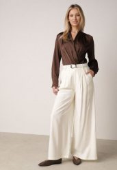 Białe Szerokie Spodnie Wiskozowe w Garniturowym Stylu z Paskiem Qera. Białe spodnie materiałowe damskie Born2be, bez wzorów, z jeansu, eleganckie. Za 129.99 zł.