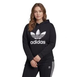 Bluza sportowa damska Adidas Trefoil Hoodie oversize. Czarne bluzy damskie Adidas, plus size, bez wzorów, z bawełny, klasyczne, bez ramiączek, z kapturem. Za 192.00 zł.