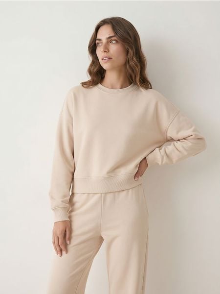 Krótka bluza crewneck - beżowy. Brązowe bluzy damskie Sinsay, l, bez wzorów, sportowe, bez ramiączek, bez kaptura. Za 49.99 zł.