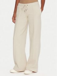 Guess Jeans Spodnie dresowe W5BB04 KC811 Beżowy Wide Leg. Brązowe spodnie dresowe damskie Guess Jeans, z aplikacjami, z bawełny. Za 349.99 zł.