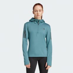 Bluza Own The Run Winterized Hooded Half-Zip. Niebieskie bluzy damskie Adidas, xs, bez wzorów, bez ramiączek, z kapturem. W wyprzedaży za 224.20 zł.