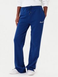 Guess Jeans Spodnie dresowe W5YB32 K68I4 Niebieski Regular Fit. Niebieskie spodnie dresowe damskie Guess Jeans, z aplikacjami, z bawełny. Za 299.99 zł.