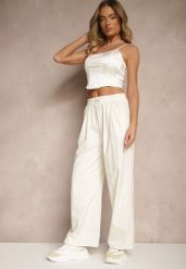 Jasnobeżowe Spodnie o Szerokim Kroju z Bawełną High Waist Ozdobione Naszywką Naneriela. Brązowe spodnie materiałowe damskie Renee, z aplikacjami, z bawełny, eleganckie, z podwyższonym stanem. Za 49.99 zł.