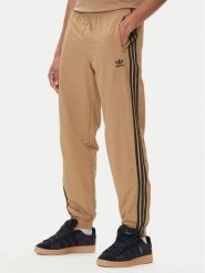 Adidas Spodnie dresowe adicolor Woven Firebird JY1339 Beżowy Regular Fit. Brązowe spodnie sportowe męskie Adidas, m, bez wzorów, z dresówki. Za 219.99 zł.