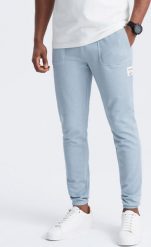 Ombre Spodnie męskie dresowe ze strukturalnej dzianiny - jasnoniebieskie V4 OM-PASK-0211 L. Niebieskie spodnie sportowe męskie Ombre, l, bez wzorów, z dresówki. Za 169.99 zł.