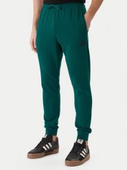 Adidas Spodnie dresowe Essentials Feel Cozy JE3858 Zielony Regular Fit. Zielone spodnie sportowe męskie Adidas, m, bez wzorów, z dresówki. Za 219.99 zł.