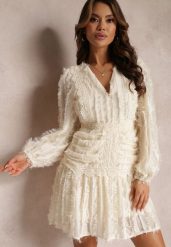 Beżowa Sukienka Rozkloszowana z Wystrzępieniem i Koronką Avela. Brązowe sukienki damskie Renee, na imprezę, l, bez wzorów, z koronki, bez kołnierzyka, bez ramiączek, mini, rozkloszowane. Za 139.99 zł.