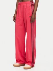 Adidas Spodnie dresowe Firebird Loose Tracksuit KW0228 Różowy Loose Fit. Czerwone spodnie dresowe damskie Adidas, bez wzorów, z dresówki. Za 299.99 zł.