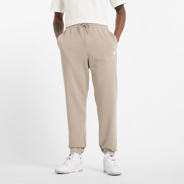 Spodnie męskie New Balance MP41519ADS – beżowe. Brązowe spodnie sportowe męskie New Balance, m, bez wzorów, z bawełny. Za 249.99 zł.