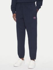 Calvin Klein Jeans Spodnie dresowe Monologo LV047B235G Granatowy Regular Fit. Niebieskie spodnie dresowe damskie Calvin Klein Jeans, bez wzorów, z bawełny. Za 329.99 zł.