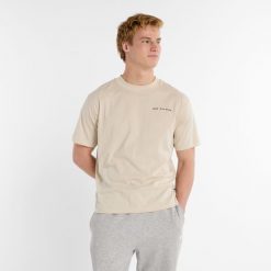 Koszulka męska New Balance MT51507TWF – beżowa. Brązowe koszulki sportowe męskie New Balance, l, bez wzorów, z bawełny, bez ramiączek. Za 89.99 zł.