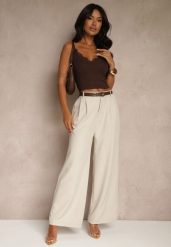 Jasnobeżowe Spodnie o Szerokim Kroju High Waist Dolarenna. Brązowe spodnie materiałowe damskie Renee, bez wzorów, z jeansu, eleganckie, z podwyższonym stanem. Za 119.99 zł.