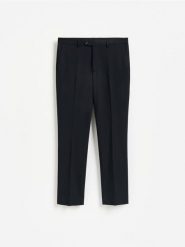 Spodnie garniturowe slim fit - granatowy. Niebieskie garnitury męskie Reserved, l, bez wzorów, z tkaniny. Za 169.99 zł.
