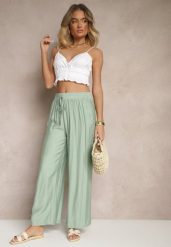 Miętowe Spodnie Typu Palazzo o Szerokim Kroju High Waist Ozdobione Wiązaniem Yaslevia. Zielone spodnie materiałowe damskie Renee, bez wzorów, z jeansu, eleganckie, z podwyższonym stanem. Za 39.99 zł.