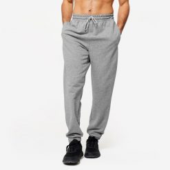 Spodnie fitness męskie Domyos Gym & Pilates. Szare spodnie sportowe męskie DOMYOS, m, bez wzorów, z bawełny, na fitness i siłownię. Za 99.99 zł.