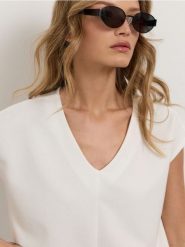 Bluza bez rękawów soft touch - kremowy. Białe bluzy damskie Sinsay, l, bez wzorów, z dzianiny, bez ramiączek, bez kaptura. Za 39.99 zł.