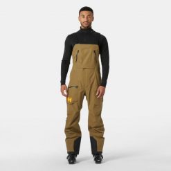 Kombinezon narciarski Helly Hansen Ridge Infinity. Brązowe spodnie sportowe męskie Helly Hansen, m, bez wzorów, narciarskie. W wyprzedaży za 2,201.50 zł.