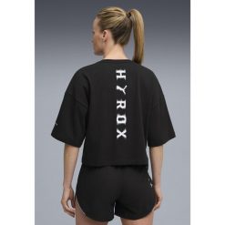 Damska skrócona koszulka PUMA x HYROX Lifestyle PUMA Black. Czarne bluzki damskie Puma, s, bez wzorów, sportowe, bez kołnierzyka, bez ramiączek. Za 179.00 zł.