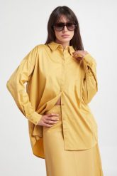 Koszula oversize z bawełnianego muślinu - złamana biel. Koszule damskie Reserved, l, bez wzorów, z bawełny, bez kołnierzyka, bez ramiączek. Za 99.99 zł.