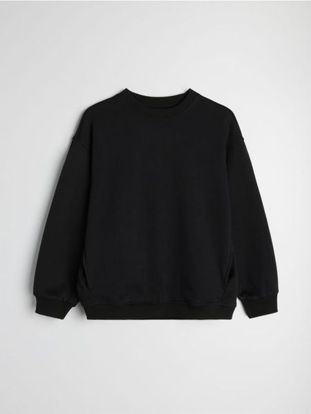 Bluza dresowa crewneck oversize - czarny. Czarne bluzy damskie Sinsay, l, bez wzorów, z dresówki, sportowe, bez ramiączek, bez kaptura. Za 39.99 zł.