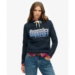 Kaptur Warstwowy. Niebieskie koszulki sportowe damskie Superdry, bez wzorów, bez ramiączek. Za 333.80 zł.