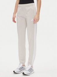 Adidas Spodnie dresowe Tricot 3-Stripes JD4536 Beżowy Regular Fit. Brązowe spodnie dresowe damskie Adidas, bez wzorów, z dresówki. Za 149.99 zł.