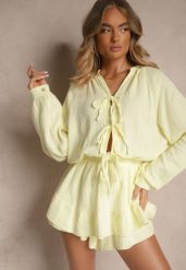 Żółty Kombinezon z Bawełny Ozdobiony Wiązaniem i Falbankami Nalelia. Żółte sukienki damskie Renee, na co dzień, bez wzorów, z bawełny, eleganckie, bez kołnierzyka, bez ramiączek, kopertowe. Za 139.99 zł.