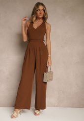 Brązowy Kombinezon o Taliowanym Kroju z Dekoltem Halter i Wiązanym Paskiem Malisena. Brązowe sukienki damskie Renee, na co dzień, l, bez wzorów, eleganckie, bez kołnierzyka, bez ramiączek. Za 99.99 zł.
