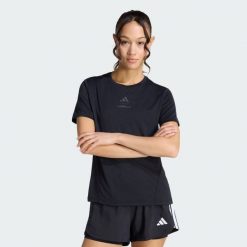 Koszulka Les Mills Graphic. Czarne bluzki damskie Adidas, bez wzorów, sportowe, bez kołnierzyka, bez ramiączek. Za 199.00 zł.