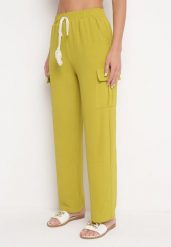 Jasnozielone Luźne spodnie Palazzo z Gumką w Pasie i Kieszeniami z Klapami Rannestia. Zielone spodnie materiałowe damskie Born2be, bez wzorów, z jeansu, eleganckie. Za 49.99 zł.