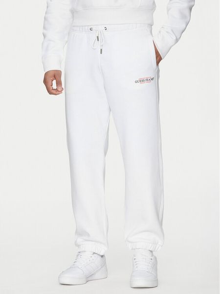 Guess Jeans Spodnie dresowe M4YB18 K9V31 Biały Regular Fit. Białe spodnie sportowe męskie Guess Jeans, m, z aplikacjami, z bawełny. Za 159.99 zł.