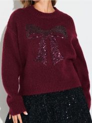 Sweter z cekinową aplikacją w kształcie kokardy i domieszką wełny - różowy. Czerwone swetry nierozpinane damskie Sinsay, l, z aplikacjami, z wełny, bez kołnierzyka, bez ramiączek. Za 69.99 zł.