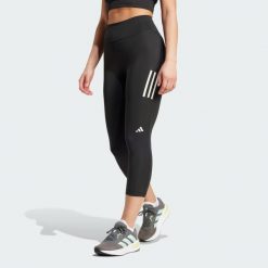 Legginsy Own the Run 3/4. Czarne legginsy damskie Adidas, bez wzorów, z materiału. Za 259.00 zł.