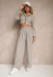 Jasnoszare Spodnie o Szerokim Kroju z Bawełną High Waist Ozdobione Naszywką Naneriela. Szare spodnie materiałowe damskie Renee, z aplikacjami, z bawełny, eleganckie, z podwyższonym stanem. Za 49.99 zł.