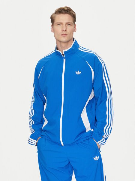 Adidas Bluza adicolor Teamgeist JP1117 Niebieski Regular Fit. Niebieskie bluzy męskie Adidas, m, bez wzorów, z syntetyku, bez ramiączek, bez kaptura. Za 259.99 zł.