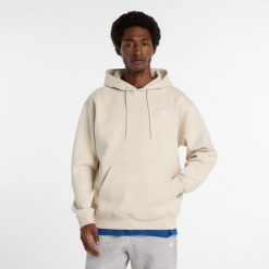 Bluza męska New Balance MT41511TWF – beżowa. Brązowe bluzy męskie New Balance, l, z aplikacjami, z bawełny, z kapturem. Za 299.99 zł.