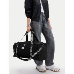 Torba weekendowa Guess Jeans. Czarne torby podróżne damskie Guess Jeans, z aplikacjami, z jeansu. Za 299.99 zł.