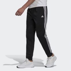 Spodnie męskie adidas Primegreen Essentials Warm-Up Tapered 3-Stripes Track. Białe spodnie sportowe męskie Adidas, m, bez wzorów, z dresówki, na fitness i siłownię. Za 147.00 zł.