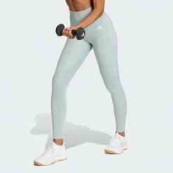 Długie legginsy Optimé Essentials Stash Pocket. Zielone legginsy damskie Adidas, bez wzorów. Za 199.00 zł.