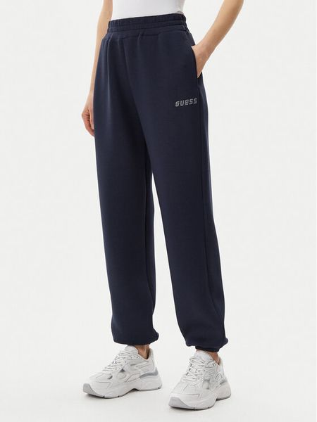 Guess Spodnie dresowe V4BB13 K7UW2 Granatowy Regular Fit. Niebieskie spodnie dresowe damskie Guess, z aplikacjami, z dresówki. Za 189.99 zł.