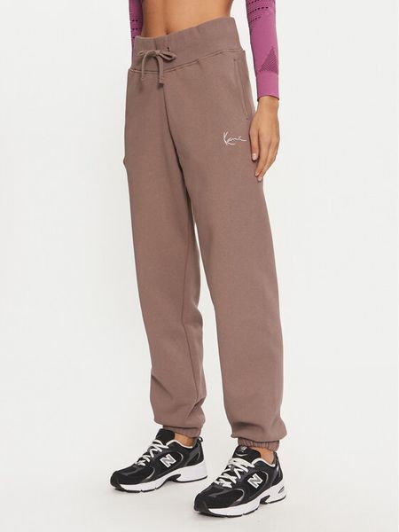 Karl Kani Spodnie dresowe Small Signature 61030014 Beżowy Relaxed Fit. Brązowe spodnie dresowe damskie Karl Kani, bez wzorów, z dresówki. Za 199.99 zł.
